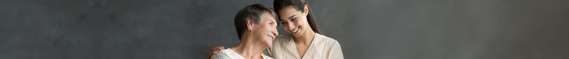 senior woman smiling with caregiver